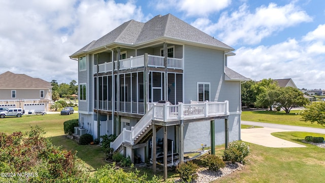 back of property featuring a balcony and a lawn