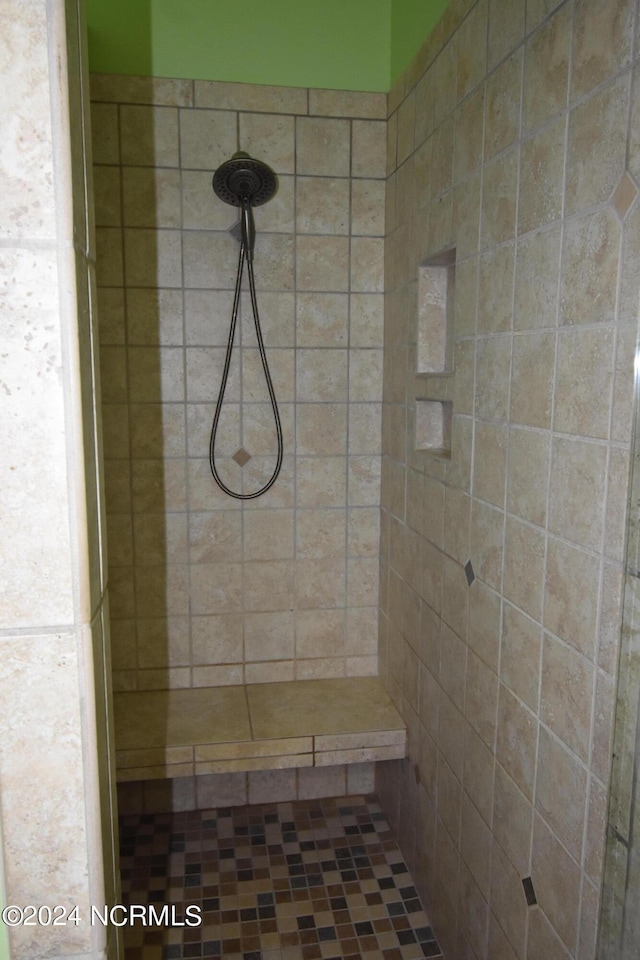 bathroom with tiled shower