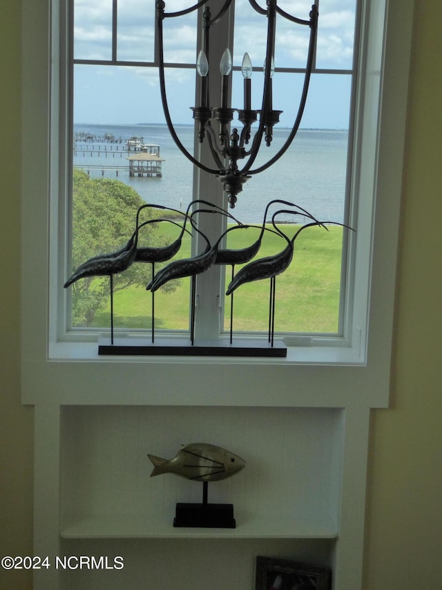 room details featuring a water view and an inviting chandelier