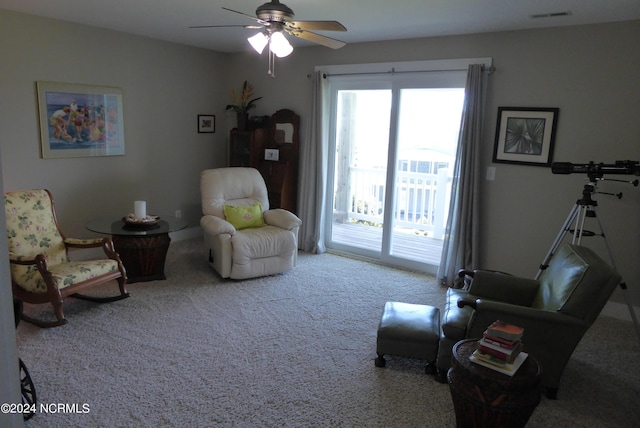 sitting room featuring ceiling fan and light carpet