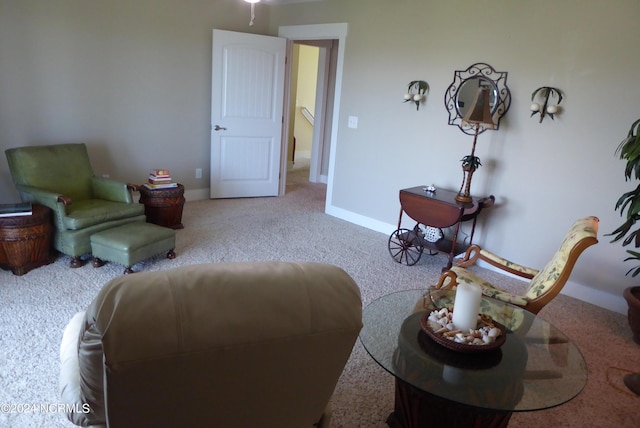 sitting room featuring light carpet