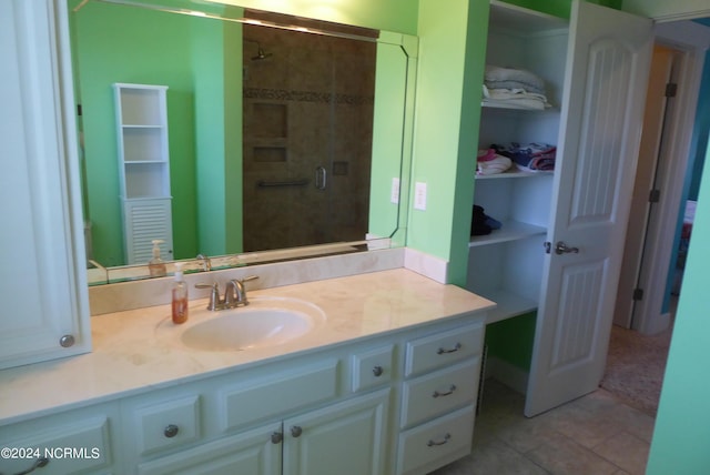 bathroom featuring tile patterned floors, vanity, and tiled shower