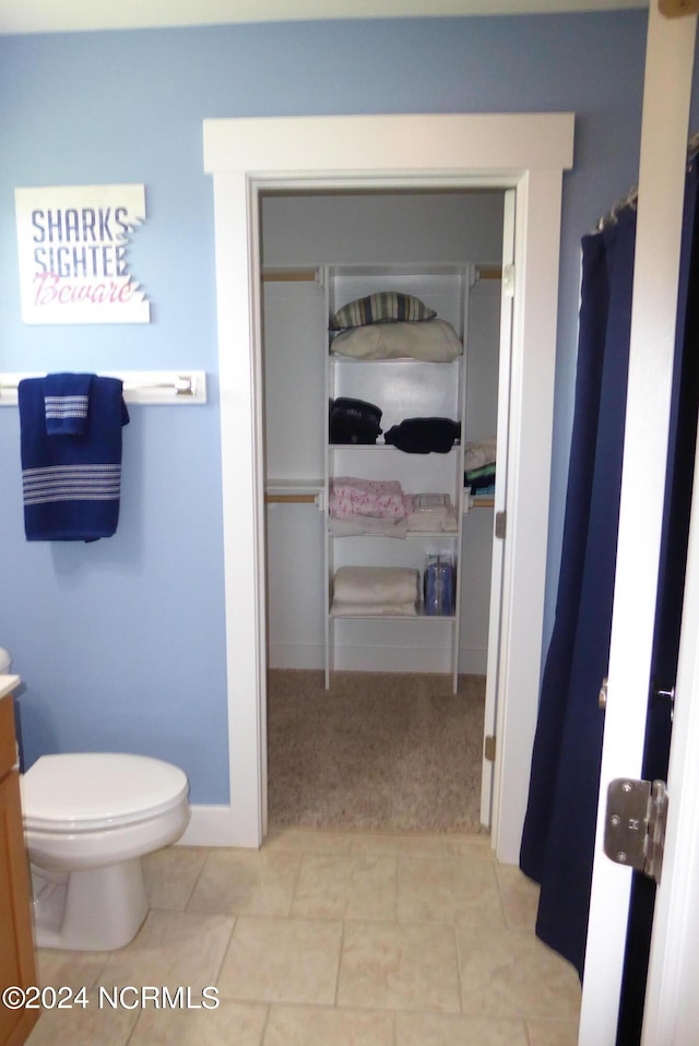 bathroom with tile patterned flooring, vanity, and toilet