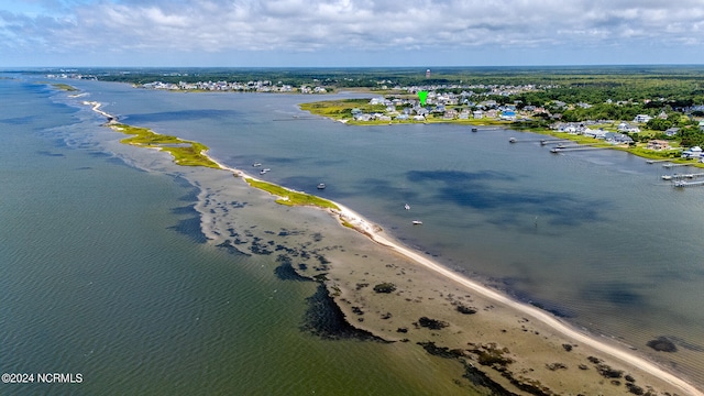 bird's eye view featuring a water view and a beach view