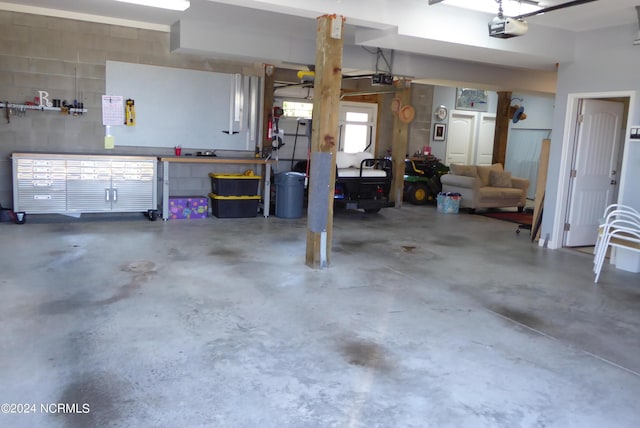 garage with a workshop area and a garage door opener