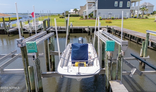 dock area with a yard and a water view