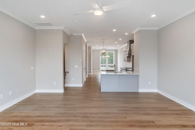 2597 Alvernia Dr, Castle Hayne, NC 28429 - kitchen with crown molding, recessed lighting, a ceiling fan, light wood-style floors, and light countertops