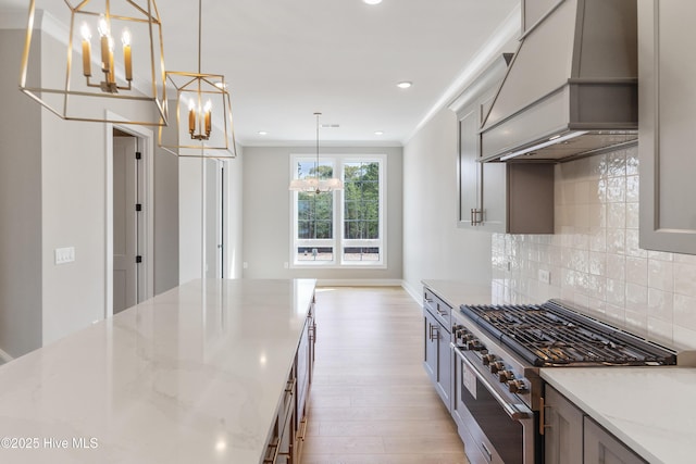 2597 Alvernia Dr, Castle Hayne, NC 28429 - kitchen with high end range, custom exhaust hood, a chandelier, light wood-type flooring, and recessed lighting