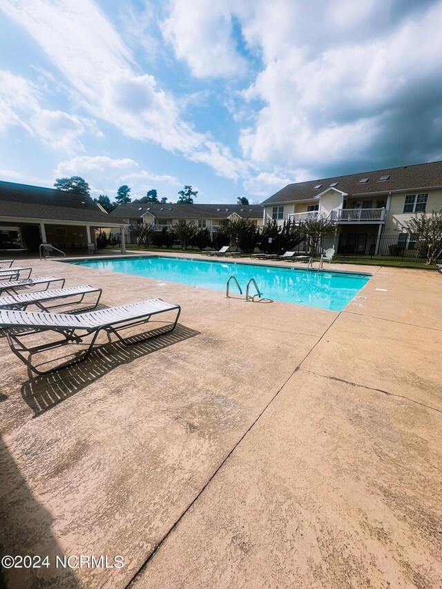 view of swimming pool with a patio area