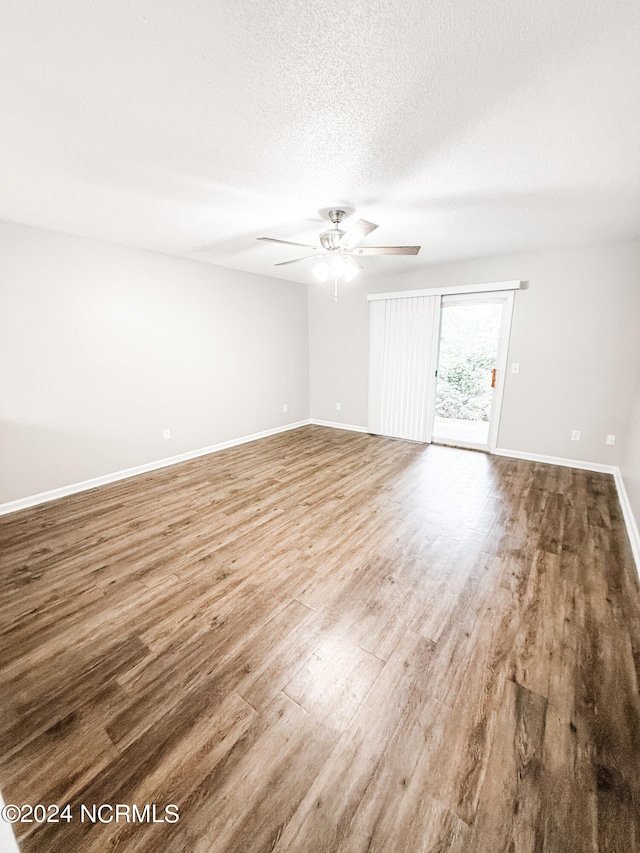 unfurnished room featuring a textured ceiling, hardwood / wood-style flooring, and ceiling fan