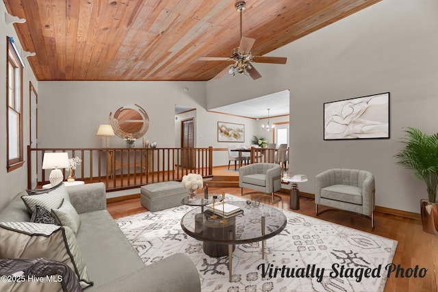 living room featuring hardwood / wood-style flooring, vaulted ceiling, ceiling fan with notable chandelier, and wood ceiling