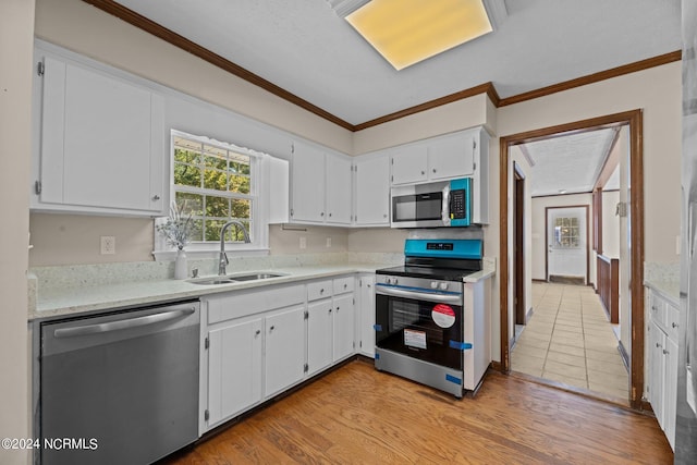 kitchen with white cabinetry, sink, stainless steel appliances, crown molding, and light hardwood / wood-style flooring