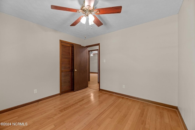 unfurnished room with ceiling fan and light wood-type flooring