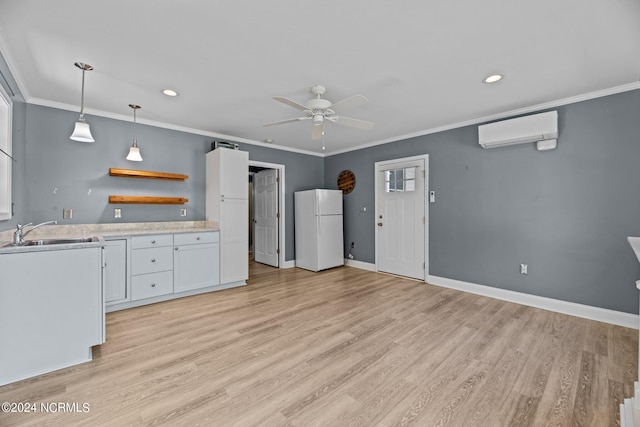 kitchen featuring white cabinetry, sink, a wall mounted air conditioner, and white fridge