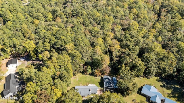 birds eye view of property with a forest view