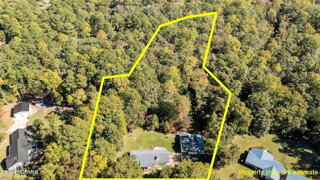 birds eye view of property with a view of trees