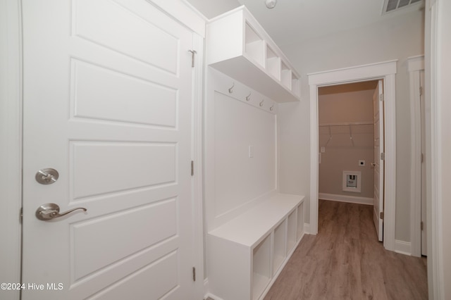 mudroom featuring light wood-type flooring, visible vents, and baseboards