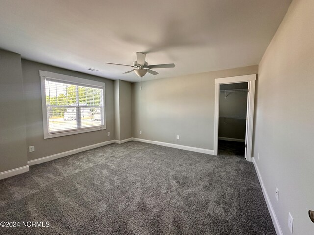 207 Eaton St, Carthage, NC 28327 - empty room featuring a ceiling fan, dark colored carpet, and baseboards