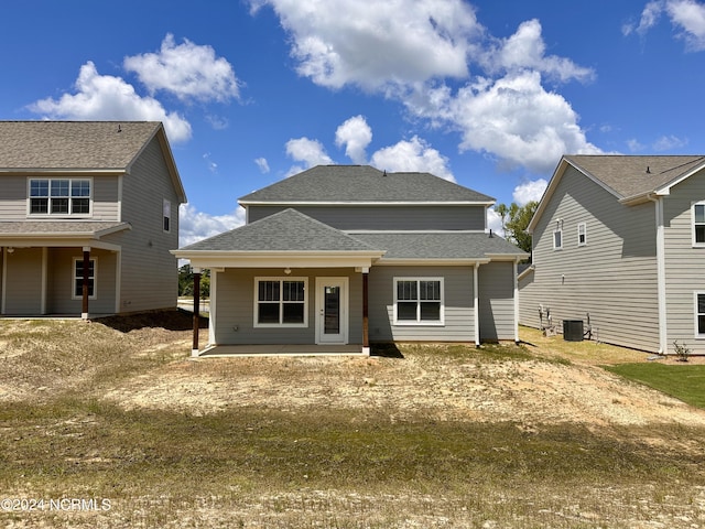 rear view of house featuring central AC unit and a patio