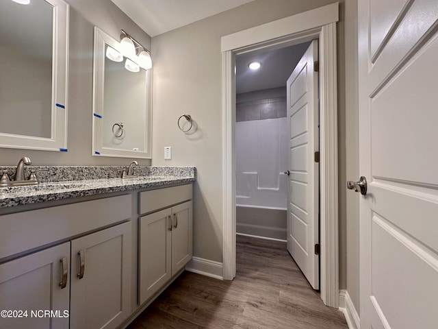 207 Eaton St, Carthage, NC 28327 - full bathroom featuring wood finished floors, baseboards, double vanity, recessed lighting, and bathtub / shower combination