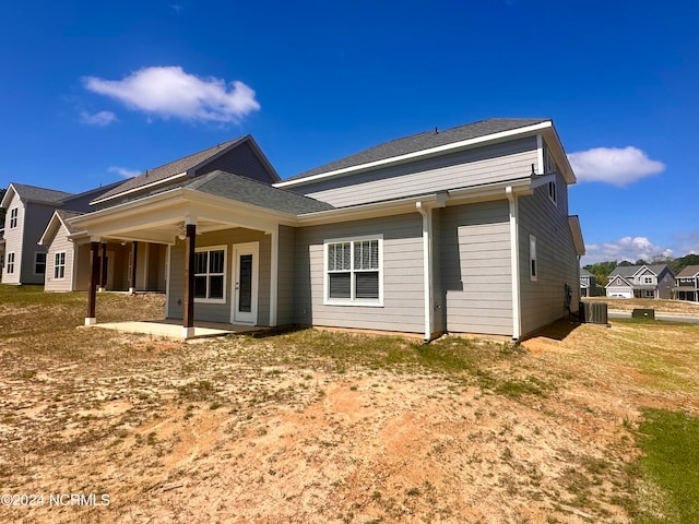 rear view of property with central AC and a patio area