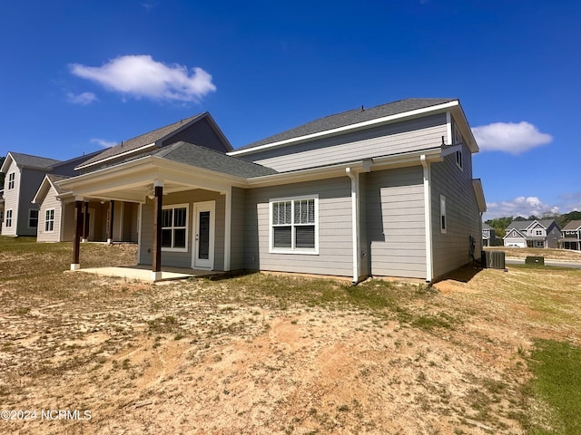 rear view of property with a patio area and central AC