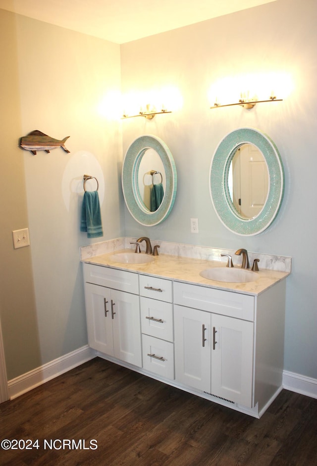 bathroom featuring dual vanity and hardwood / wood-style floors