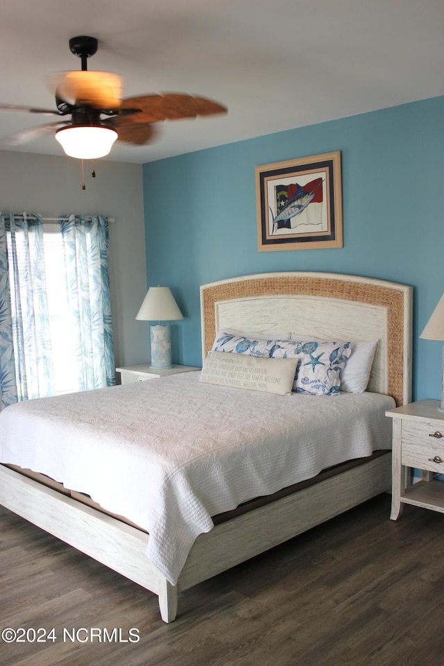 bedroom featuring ceiling fan and dark hardwood / wood-style floors