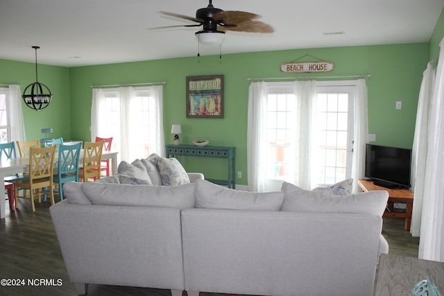 living room featuring dark hardwood / wood-style floors, ceiling fan, and a wealth of natural light