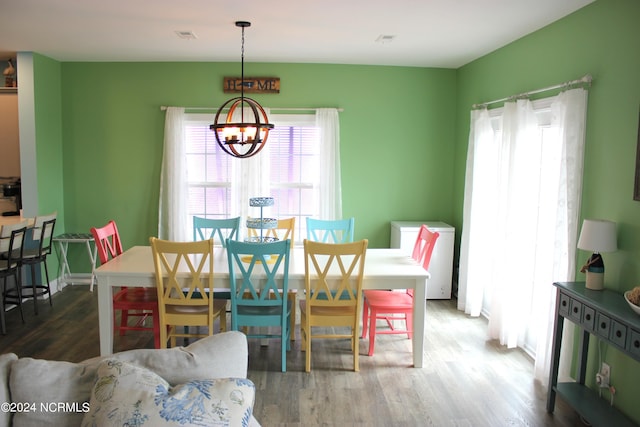 dining room featuring an inviting chandelier and wood-type flooring