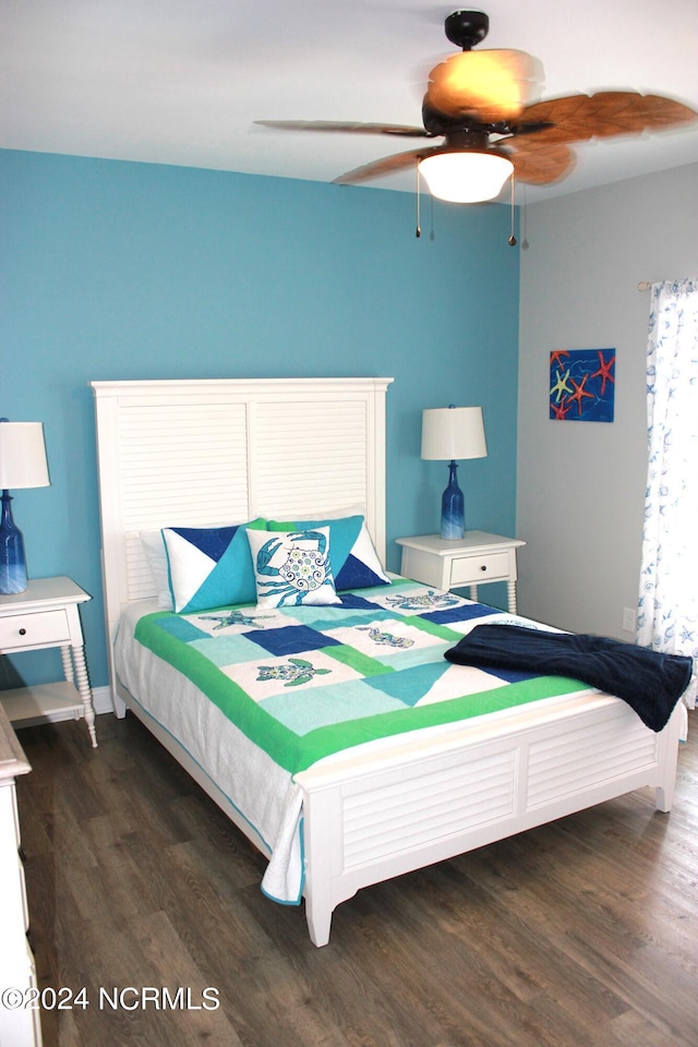 bedroom with dark hardwood / wood-style floors and ceiling fan