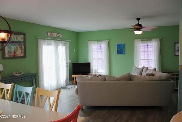 living room with wood-type flooring and ceiling fan