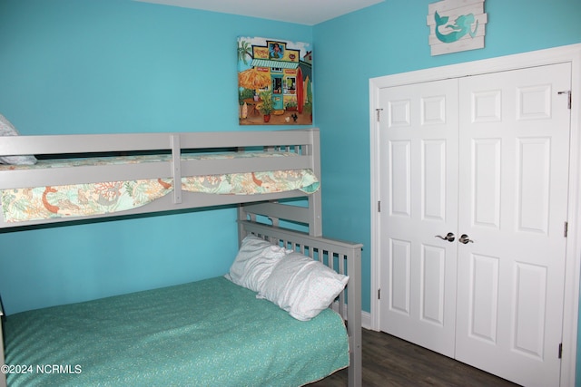 bedroom with a closet and dark wood-type flooring