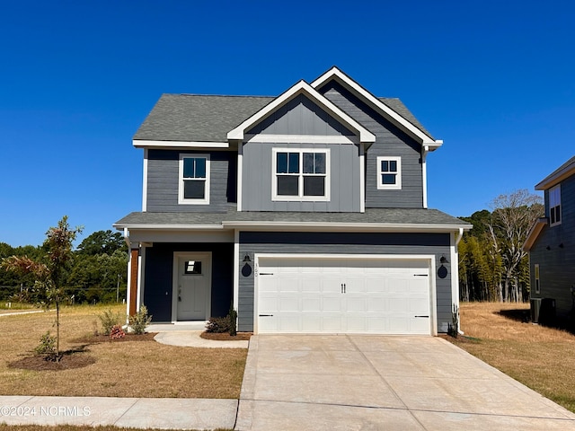 view of front of house featuring a garage and a front yard