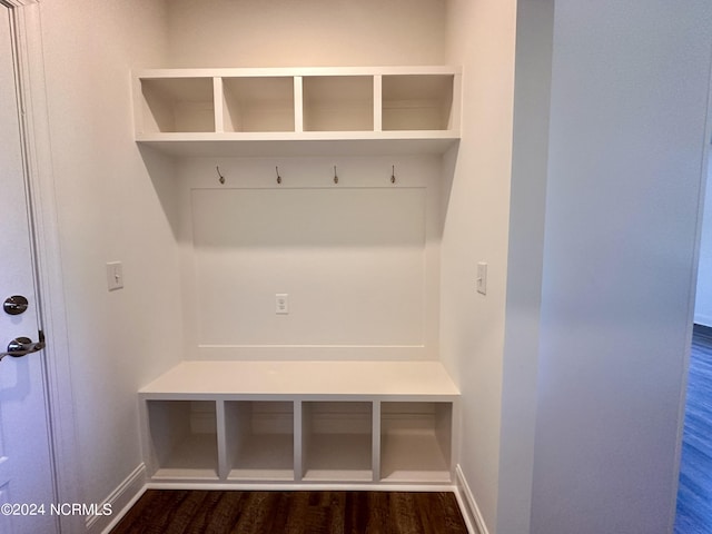 mudroom with dark wood-style floors and baseboards