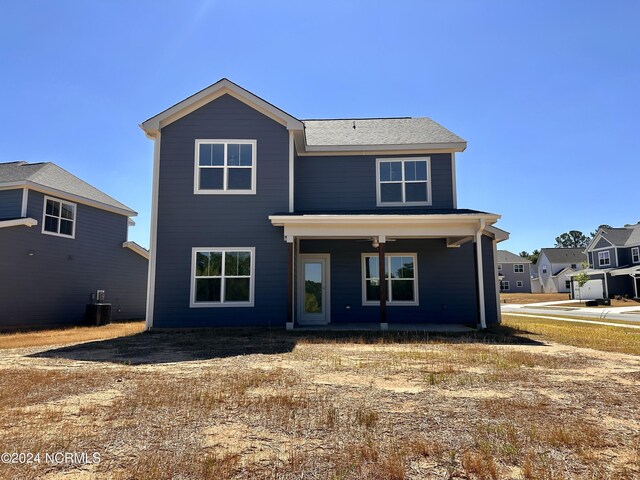 view of front property featuring a porch and central AC