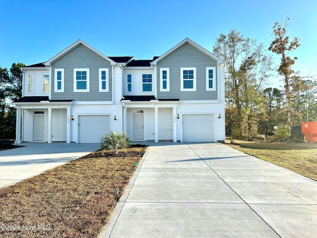 view of front of home featuring a garage and a front yard