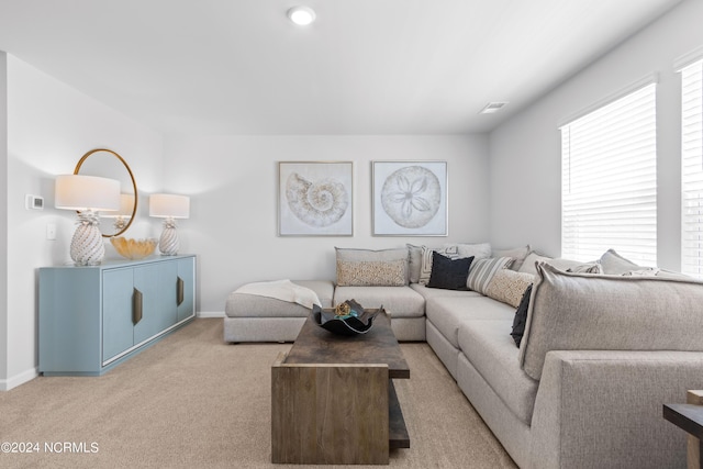 carpeted living room with visible vents and baseboards