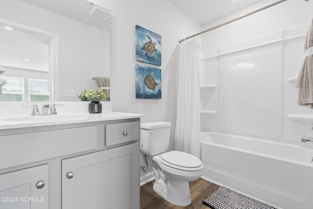 full bath with visible vents, toilet, shower / bath combo with shower curtain, vanity, and wood finished floors