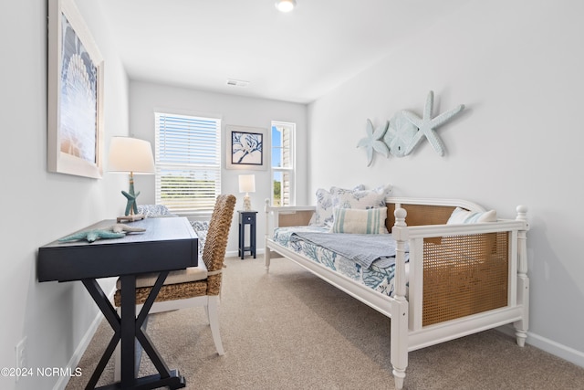 carpeted bedroom with visible vents and baseboards