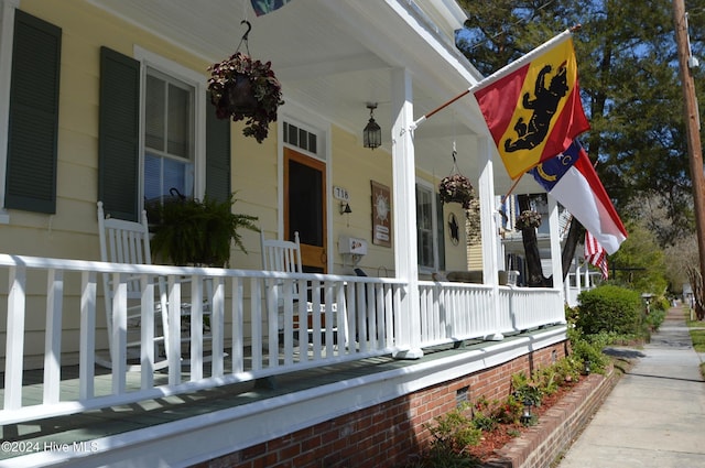 view of side of home with covered porch