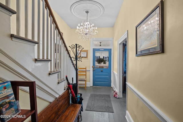 entrance foyer featuring a chandelier and dark hardwood / wood-style flooring