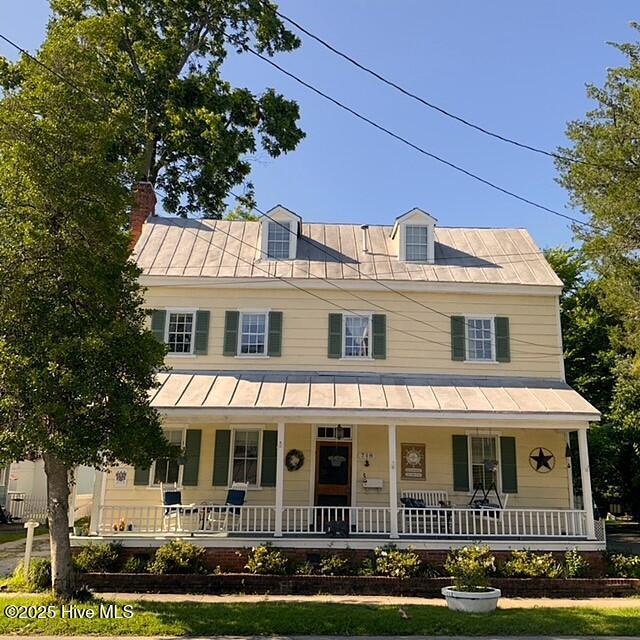 farmhouse inspired home with covered porch