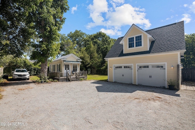 view of front of property with a garage and a deck