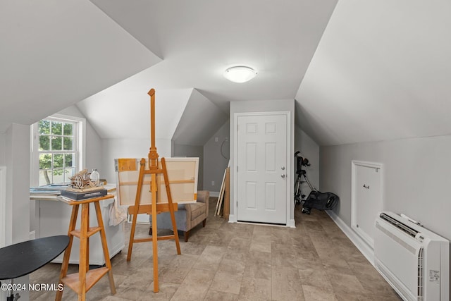 interior space featuring a wall unit AC and lofted ceiling