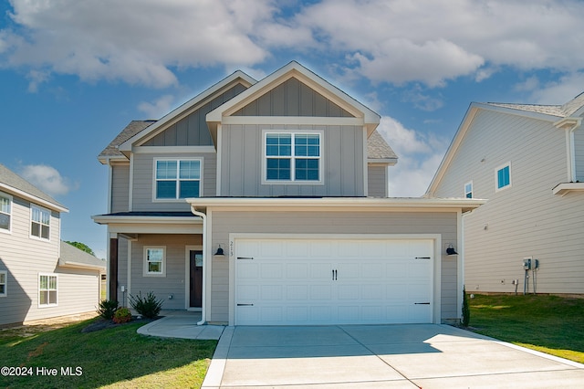 view of front of home with a garage and a front yard