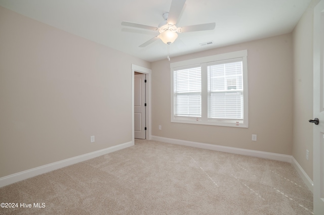 empty room with light carpet and ceiling fan