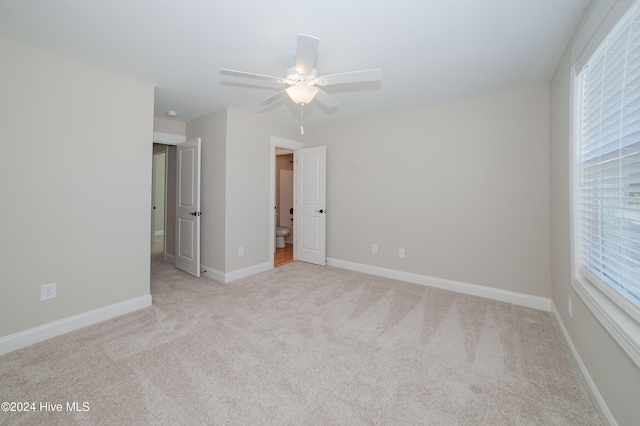 carpeted empty room with ceiling fan