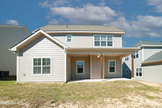 rear view of house with central AC unit, a lawn, ceiling fan, and a patio area