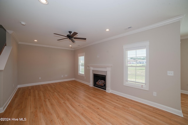 unfurnished living room featuring light wood-type flooring, ceiling fan, and crown molding